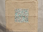 Beige Crochet Cushion Cover with Teal‑Floral Center Patch & Scalloped Lace Edge
