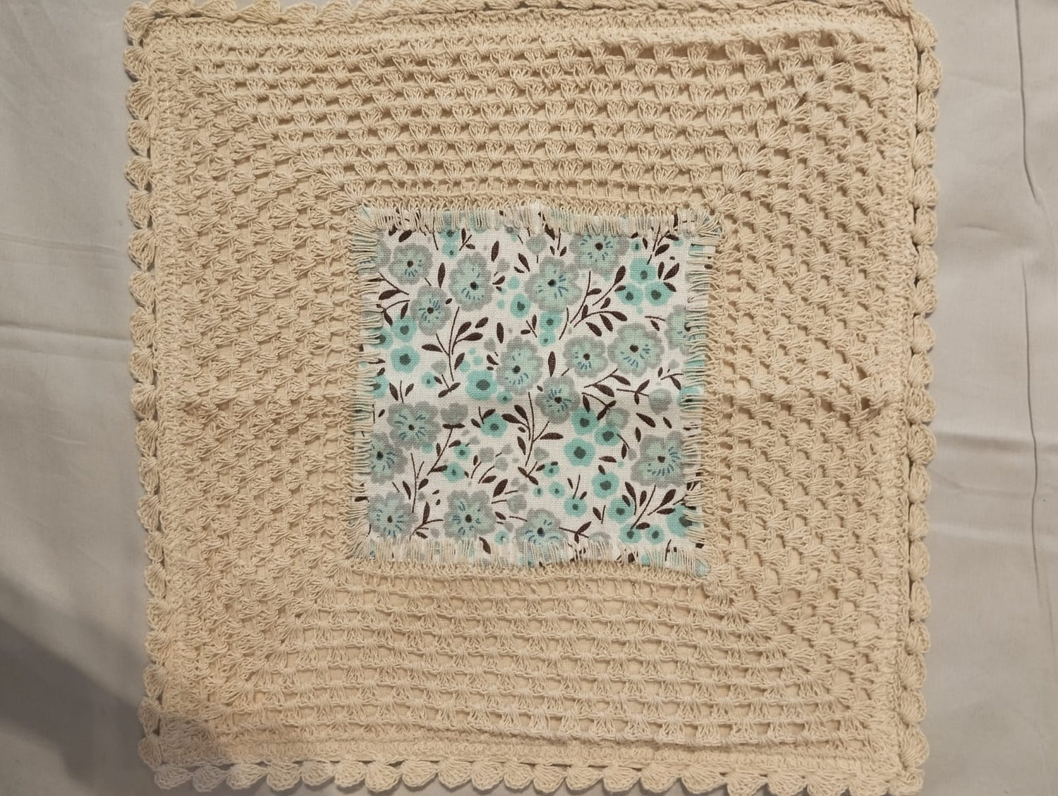 Beige Crochet Cushion Cover with Teal‑Floral Center Patch & Scalloped Lace Edge