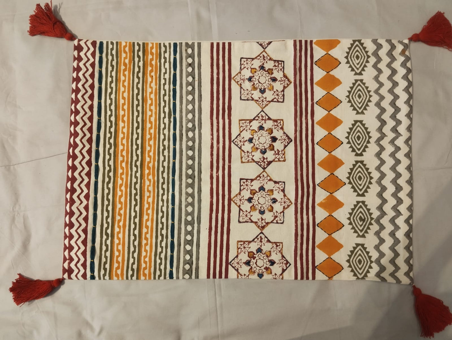 Vibrant Tribal Stripe & Geometric Medallion Cushion Cover with Red Tassel Accents