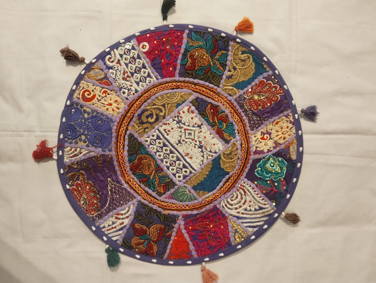 Jaipur Radiant Embroidered Round Cushion Cover with Purple Base, Floral Panels & Multicolored Tassels