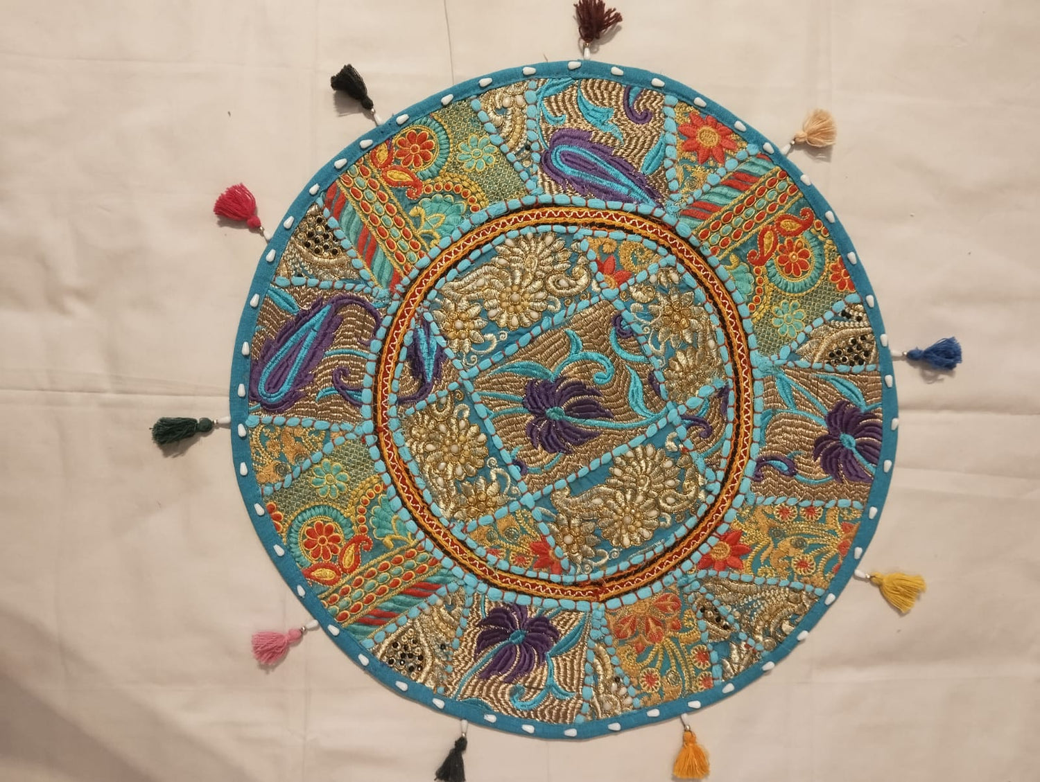 Jaipur Turquoise Embroidered Round Cushion Cover with Multicolour Tassels & Zari Floral Design